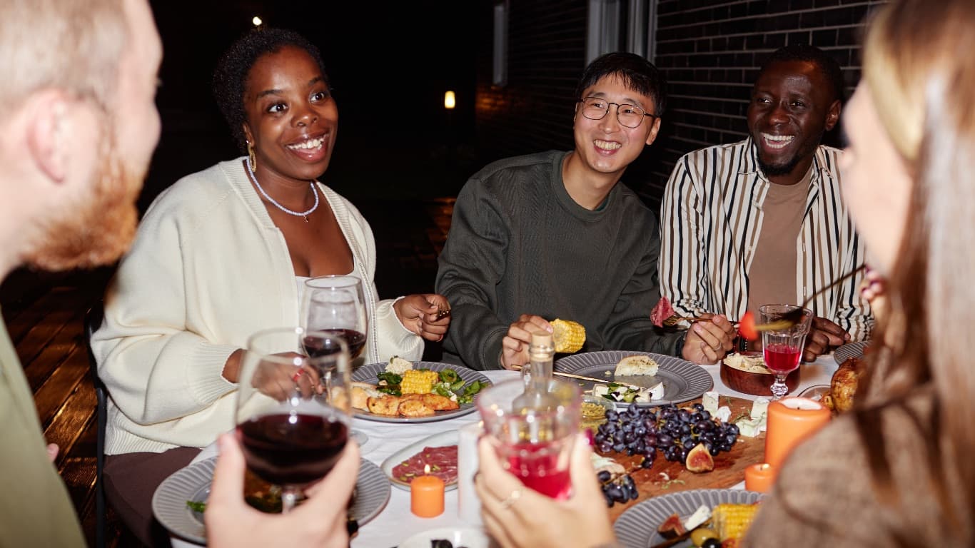 Friends laughing together over dinner