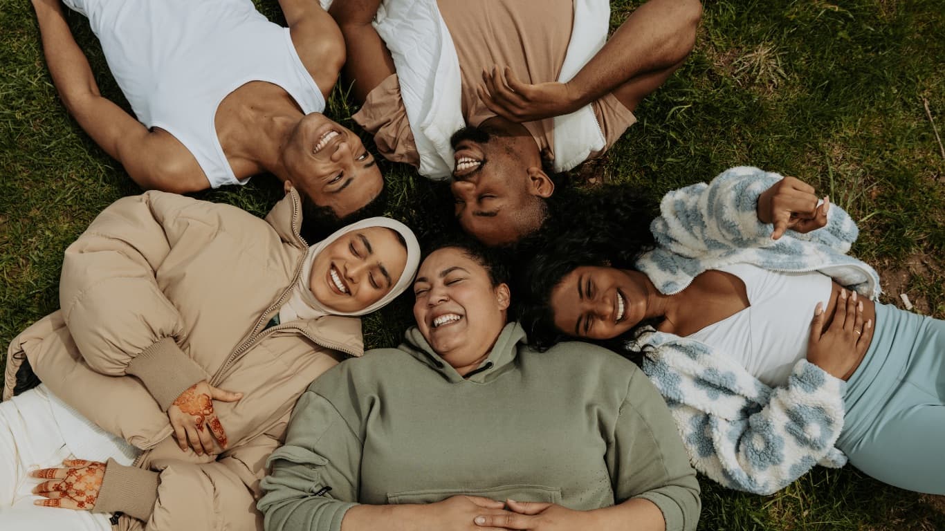 Friends laughing together on the grass